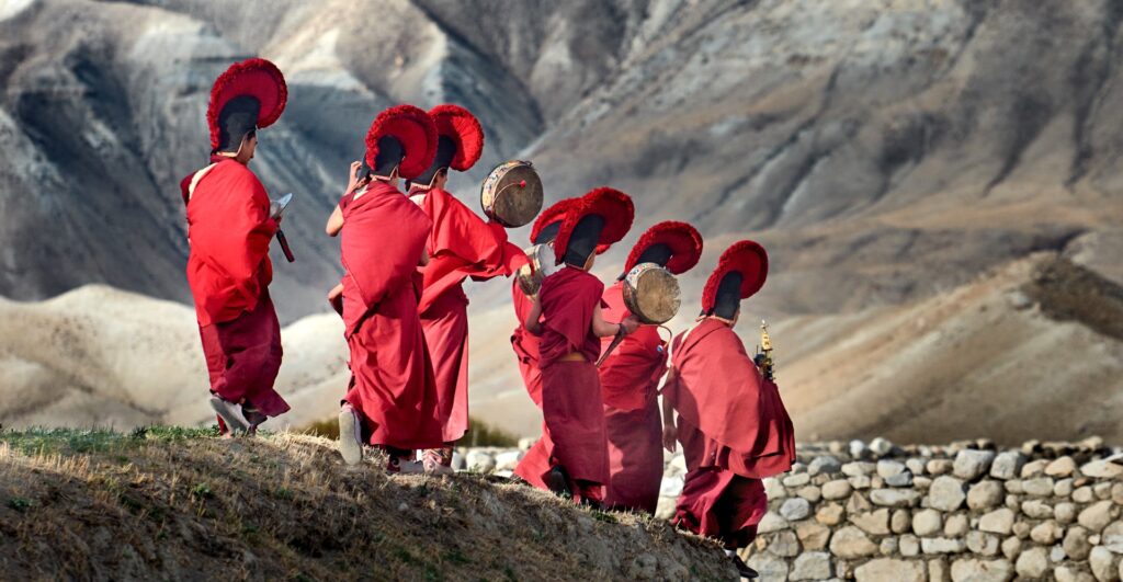 Young monks walk in Tigi festival in Mustang, Nepal - experiential travel