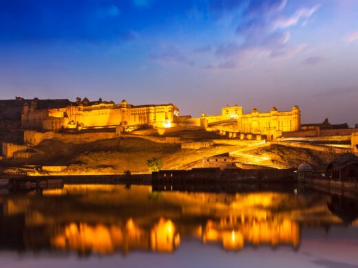 Amer Fort Amber Fort illuminated at night - one of principal attractions in Jaipur, Rajastan, India refelcting in Maota lake in twilight