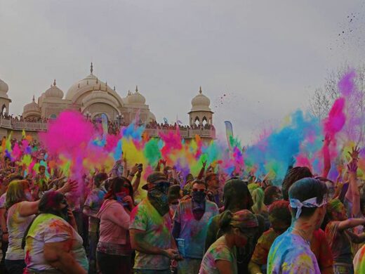 Happy people drenched in bright colors celebrating