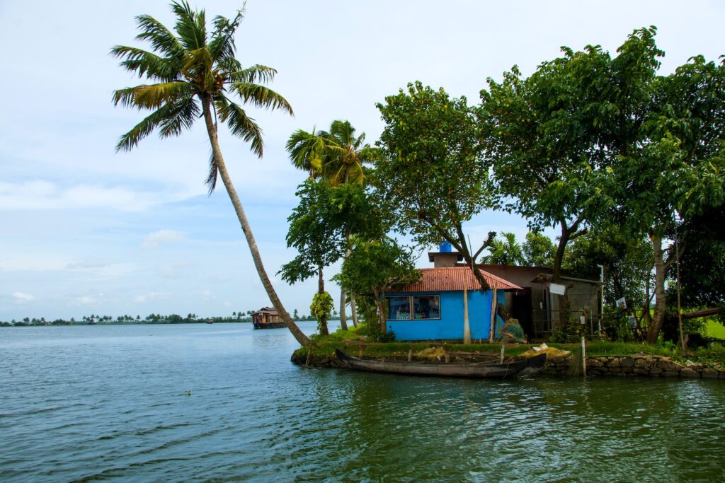Landscape of Alleppey backwaters with coconut tree and reflection in water, Kerala, India.
