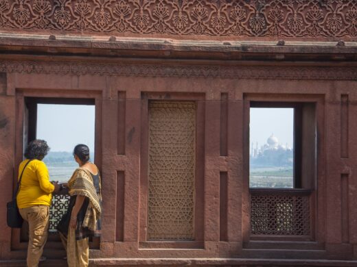 Romantic Indian couple seeing Taj Mahal from red fort, Agra, India.