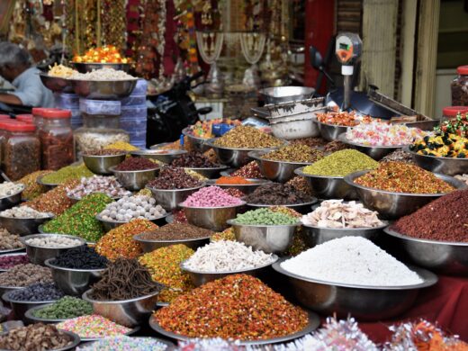 A vibrant display of various spices at a local market stall