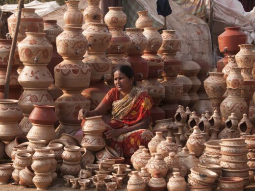 Woman selling earthen pots by the roadside at village of India.